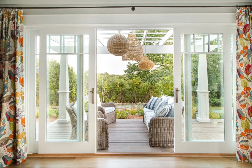 Sliding glass patio door opening onto a backyard deck